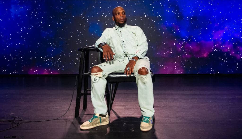 Ali Siddiq performing on stage with a cosmic starry backdrop