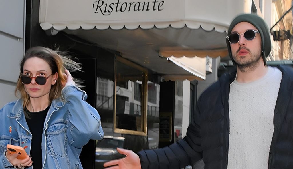 Rebecca Ferguson and Rory St. Clair Gainer walk together on a city street